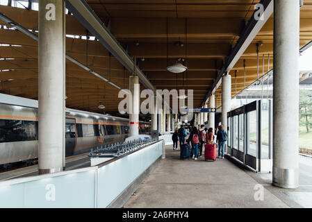 Oslo, Norway - August 12, 2019: Passengers on the platform of the Flytoget train at Oslo Gardermoen airport station Stock Photo
