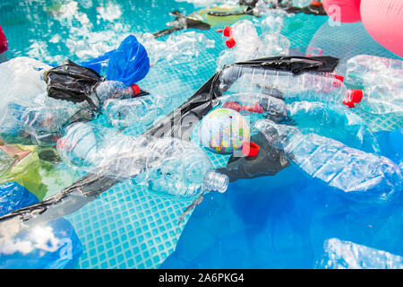 UFA, RUSSIA - JULY 25, 2019 : Problem of trash, plastic recycling, pollution and environmental concept - Plastic rubbish pollution in water Stock Photo