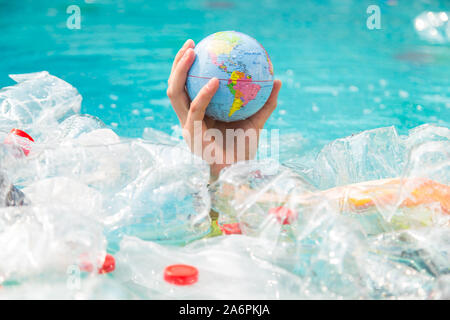 UFA, RUSSIA - JULY 25, 2019 : Problem of trash, plastic recycling, pollution and environmental concept - Plastic rubbish pollution in water Stock Photo