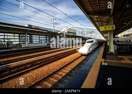 A Japan Railways Shinkansen high speed bullet train speeds into Kyoto station