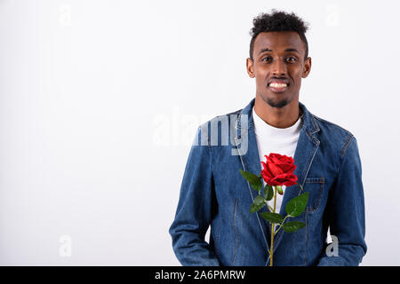 Young bearded African man wearing denim jacket against white bac Stock Photo