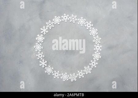 White christmas round snowflakes frame with place for text on the grey background. Holiday mock up. New year greeting card template. Scandinavian Stock Photo