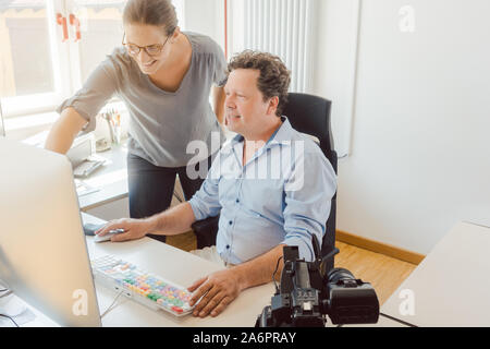 Woman and man working on a video in post-production Stock Photo