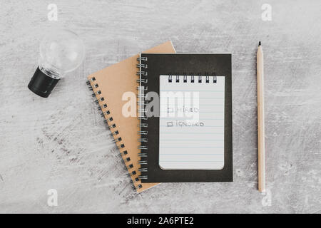 recuirment process goals conceptual still-life, notepads on business desk with Hired vs ignored options Stock Photo