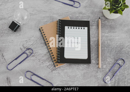 recuirment process goals conceptual still-life, notepads on business desk with Hired vs ignored options and with lightbulb Stock Photo