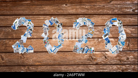 2020, snow and winter stack of photos on wooden planks background, new year card Stock Photo