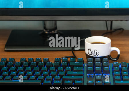 cup of coffee by the keyboard Stock Photo