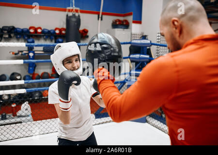 little kid practising sparring at sport center . close up photo. Stock Photo