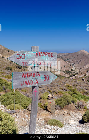 Walkers footpath sign with distance in time taken between Livadi and  Stavros bay,  Tilos, Dodecanese islands, Southern Aegean, Greece. Stock Photo