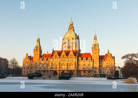 Panorama of the New town hall Rathaus and masch park in winter sunset in Hannover. There is frozen lake. Stock Photo