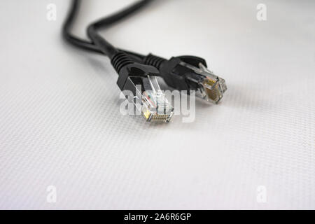 Black ethernet network cable for connections between computers and routers or local area networks Stock Photo