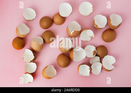 Top view of broken eggshells on a pink background Stock Photo