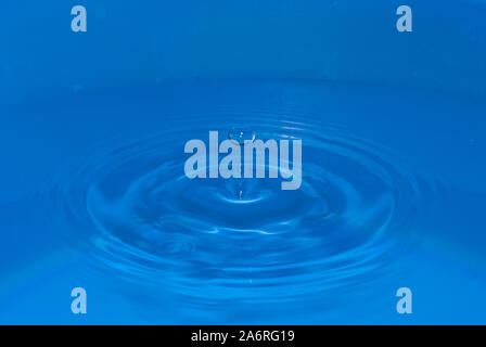 Water sculpture created by a falling drop, with drop of bounce on the top Stock Photo