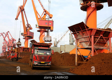 Grab bucket cranes along a quay unload iron ore from a bulk cargo ship at Lianyungang Port in Lianyungang City, east China's Jiangsu Province on Octob Stock Photo