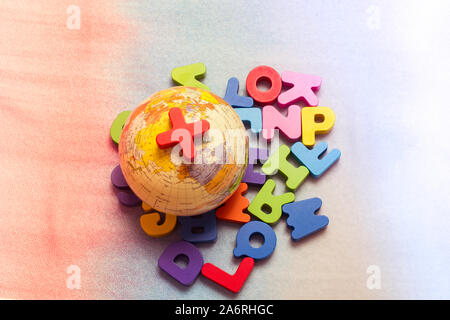 Globe model on colorful letters on a colorful background Stock Photo