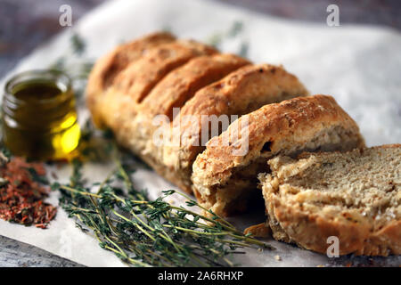 Delicious fresh homemade bread. Italian bread with herbs. Selective focus. Macro. Stock Photo