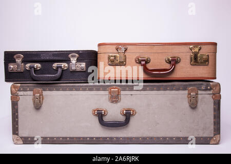 Old, retro, suitcases lie on the table with white background. Obsolete suitcase isolated on white background Stock Photo