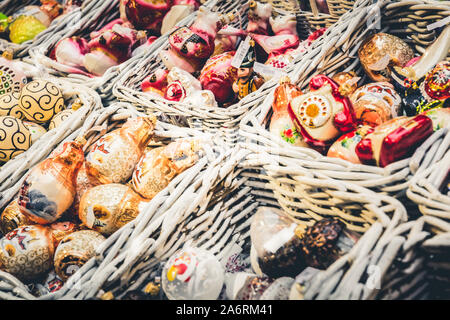 Various souvenirs in basket on christmas market. Xmas fair. Festive Holiday fair. Close up. Stock Photo