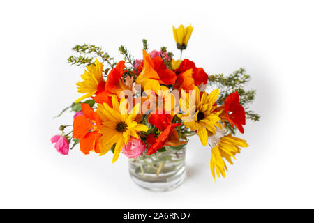 Colorful bouquet of yellow and red flowers in a vase on white background. Stock Photo