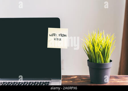 Work From Home text note on a laptop screen Stock Photo