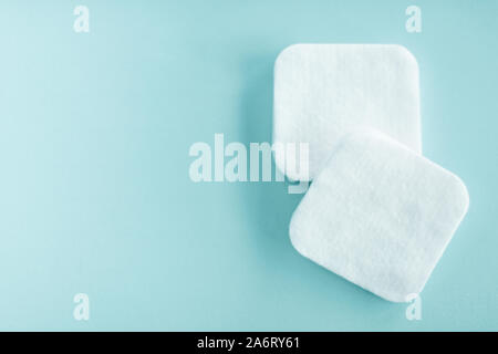 Cosmetology, cleanliness and branding concept - Organic cotton pads on mint background, cosmetics and make-up remover, hygiene and skincare beauty bra Stock Photo