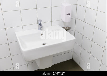 Classic modern white washbasins with chrome water tap and soap holder Stock Photo