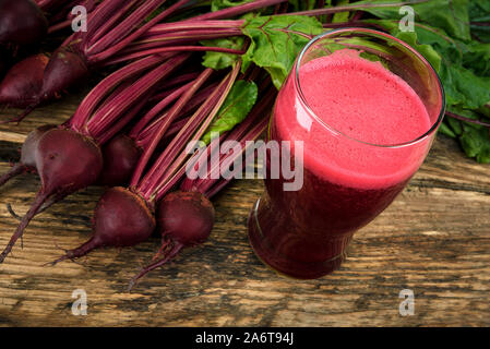 Healthy eating concept - fresh beet juice from organic farm in a glass on a wooden rustic table. Stock Photo