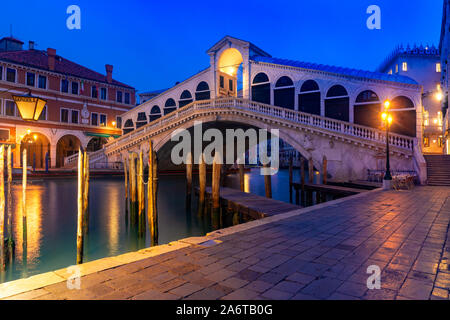 Famous Rialto Bridge or Ponte di Rialto over the Grand Canal in Venice during evening blue hour, Italy. Stock Photo