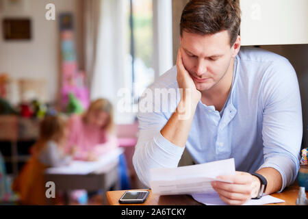 Man looking through his bills Stock Photo