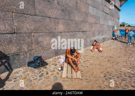 People taking sunbath on the beach near Peter and Paul Fortress in Saint Petersburg, Russia Stock Photo