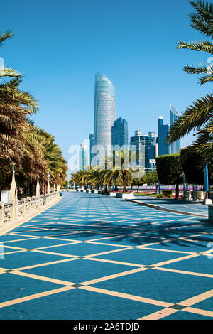 ABU DHABI, UNITED ARAB EMIRATES - JANUARY 27, 2017: Abu Dhabi Corniche walking area with landmark view of modern buildings on Corniche road, UAE Stock Photo