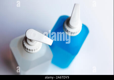 a white and a blue pump bottle with soap and hand spirit Stock Photo