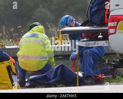 Coastguard service members aid Ambulance and police in a body recovery, Newquay Cornwall UK Stock Photo