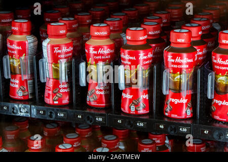 Toronto, Ontario, Canada - SEPTEMBER 27, 2019:  Two rows of bottled Tim Hortons coffee, regular and double double flavours, stacked in a vending machi Stock Photo