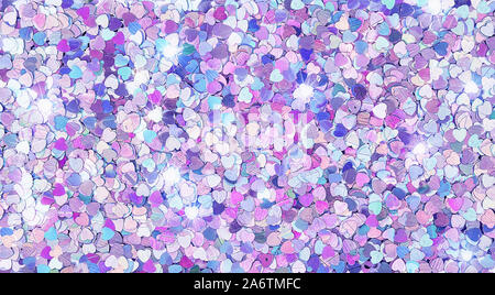 Real shiny heart-shaped sparkles textured background Stock Photo