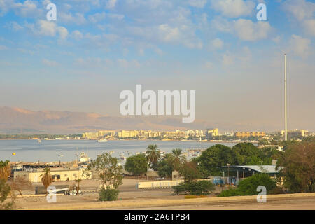 View of the Port City of Aqaba, Jordan. Buildings along the coastline with mountains in the background. Stock Photo