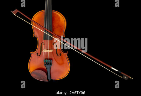Child's violin with bow isolated on black background Stock Photo
