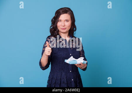 Beautiful Asian woman holds a birthday present Stock Photo