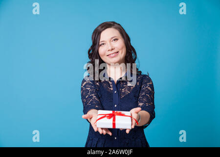 Beautiful Asian woman holds a birthday present Stock Photo