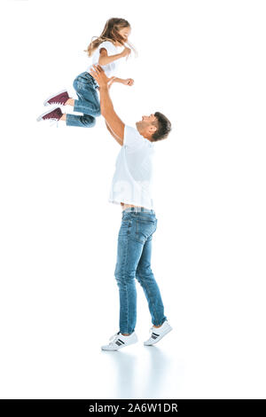 happy father holding in arms daughter while standing on white Stock Photo