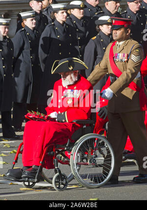 Victoria Cross recipients William Speakman (Chelsea pensioner) being pushed in his wheelchair by fellow recipient Johnson Beharry, marching past  Her Majesty The Queen and Duke of Edinburgh with other members of the British Royal family who joined join political leaders and members of the public for Remembrance service at  a wreath laying ceremony at the Cenotaph in Whitehall, London, England. November 2017. Stock Photo