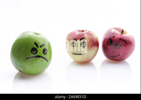 Jolly and sad funny apples. Green and red apples on a white background. Stock Photo