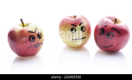 Face painted apples. Jolly and sad funny apples. Red apples on a white background. Stock Photo