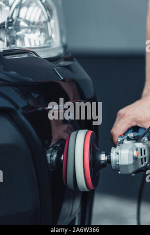 cropped view of car cleaner polishing car with buffer machine Stock Photo