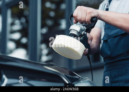 cropped view of car cleaner polishing car with buffer machine Stock Photo