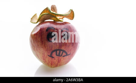 Face painted apples. Sad red apples on a white background. Stock Photo