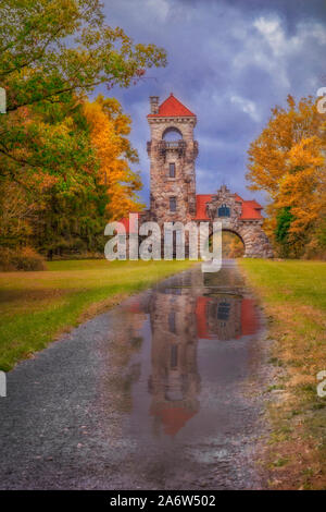Mohonk Preserve Gatehouse surrounded by the warm and bright colors of fall foliage in New Paltz, New York. Stock Photo