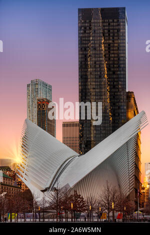 Oculus Transportation Hub with the rising sun at lower Manhattan in Stock Photo