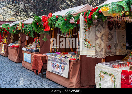 Wooden decorated kiosks with traditional craft souvenirs on Christmas market in Prague, Czech Republic. Stock Photo