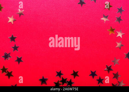 Gold stars on bright red background, abstract image Stock Photo